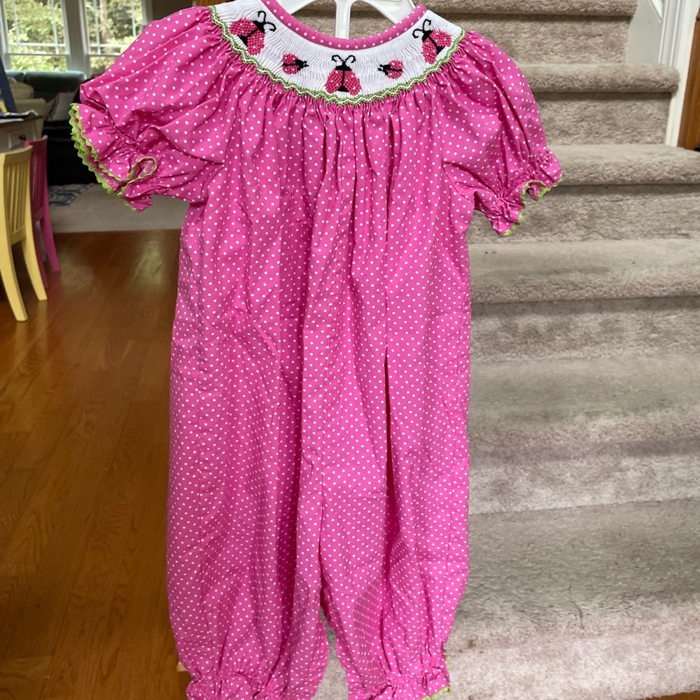 Ladybug smocked romper size 12 months. Worn once! Snaps, not buttons for legs!